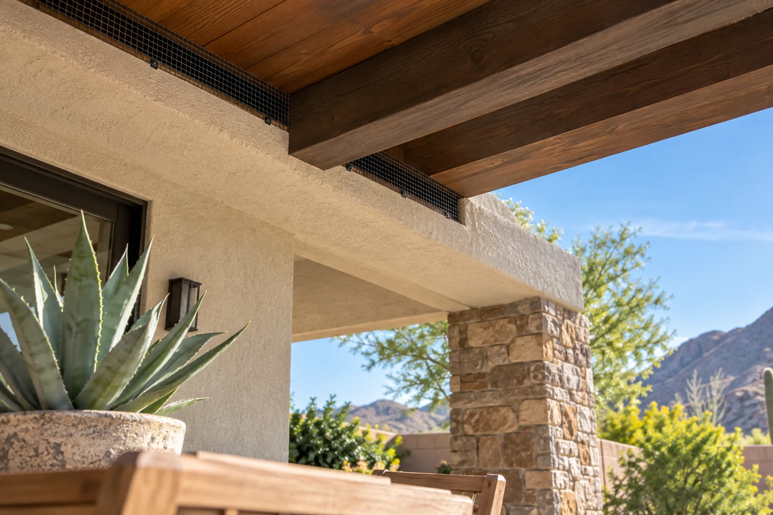 Exclusion mesh protecting a narrow roof recess above a covered desert patio